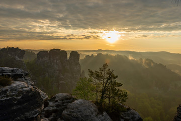 a beautiful view down in the tales from a viewpoint on the top of the Bastei in saxon switzerland, Germany