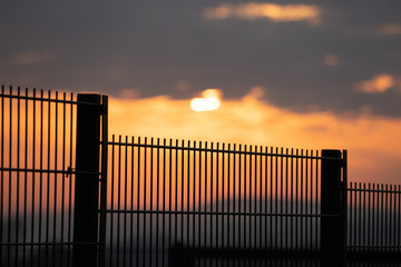 Private area fence on sunset background