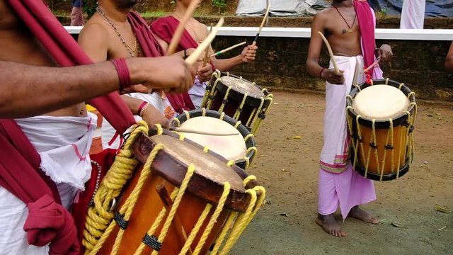 Indian men play traditional percussion instrument Chenda in Kerala, India 