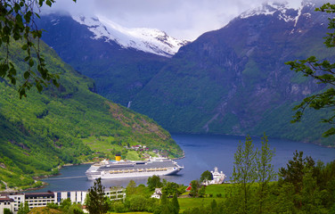 Modern cruiseships or cruise ship liners in Geirangerfjord with panoramic views of Geiranger and...