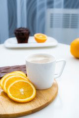 Beautiful coffee breakfast with milk and oranges. Healthy breakfast with chicory and oranges.