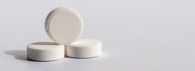 Tablets in blister and gray bottle antiseptikum lies on the steel. Place for the label.Medical topic.