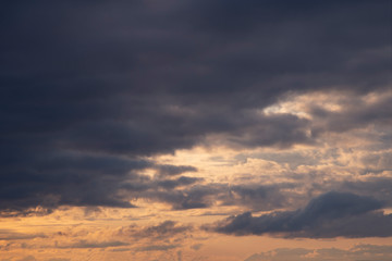 Fototapeta premium Dark blue clouds on the background sunset sky.
