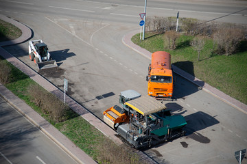 Road equipment for laying asphalt on the road