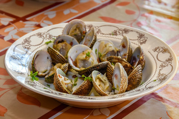 delicious shells with garlic and parsley on plate