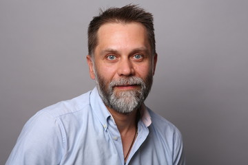 Portrait of a middle-aged man with a beard, smiling and looking at the camera