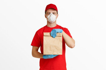 Courier in red uniform with package in hands