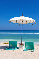 white beach umbrellas and green sunbed, gili trawangan island, Bali, Indonesia.