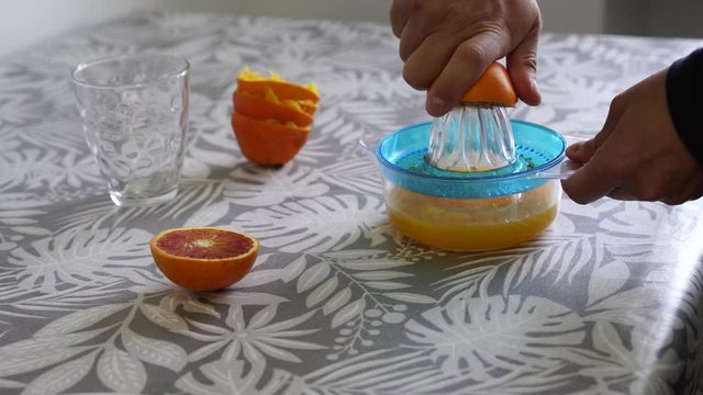 squeeze the oranges with the citrus squeezer