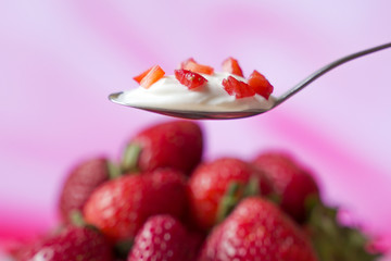 Close-up of healthy strawberry and white yogurt on the spoon, concept of healthy food nutrition