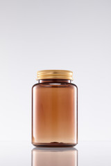 a brown glass bottle containing a drug with a lid.