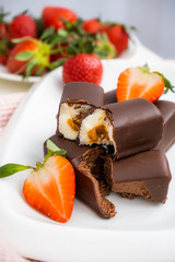 Cottage cheese curds with condensed chocolate decorated with fresh strawberries. Dessert without baking. Cottage cheese curd glazed.