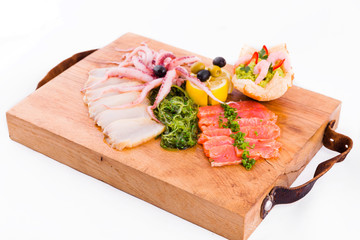 Fish platter on a wooden board on a white background