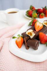 Curd cheese with boiled condensed milk in chocolate. Glazed curd cakes with coffee. Strawberry breakfast.