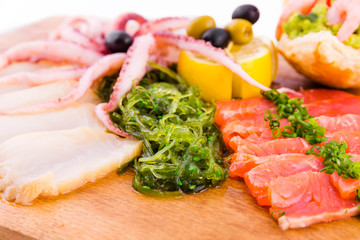 Fish platter on a wooden board on a white background