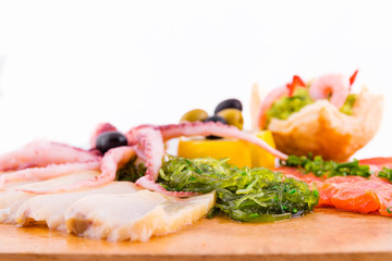 Fish platter on a wooden board on a white background