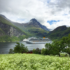 Modern Costa Cruises cruiseship or cruise ship liner Costa Favolosa in Geirangerfjord with...