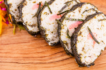 Oriental style pike perch with salmon and celery and citrus julienne on a wooden board