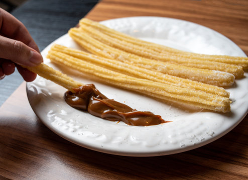CHURROS WITH MILK SWEET IN WHITE DISH
Dulce de leche