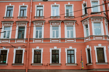 Red vintage facade. Background red house. Wall with windows.