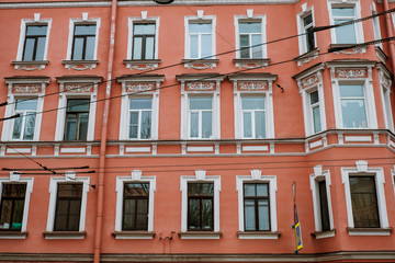 Fototapeta na wymiar Red vintage facade. Background red house. Wall with windows.