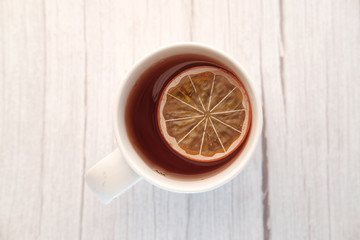 Top view of lemon tea on wooden table.