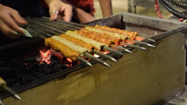 Mutton Seekh Kebab preparation in progress which is a Mughlai delicacy prepared with minced mutton, onions and a blend of spices.