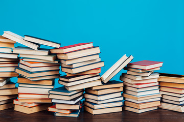 many stacks of educational books for exams at school in the library on a white background