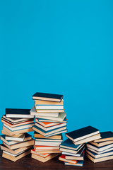 many stacks of educational books for exams at school in the library on a white background