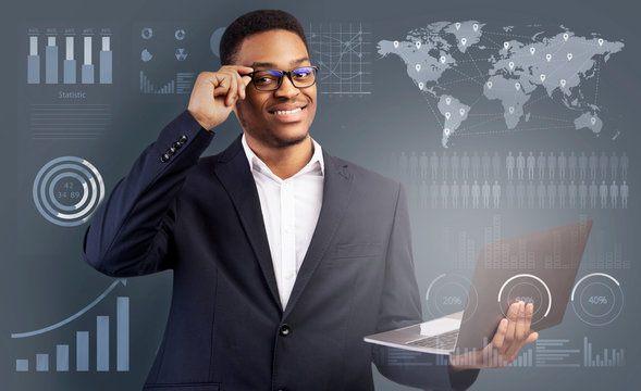 Cheerful black businessman in digital glasses with laptop