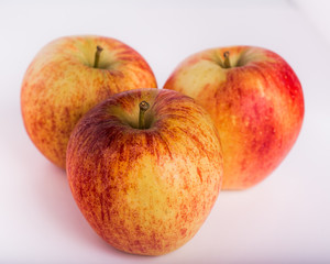 
Three delicious red and yellow apples on white background. Horizontal format.
