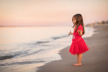 girl in red dress on the beach