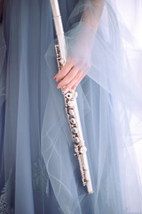 woman in blue dress holds flute