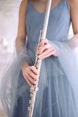 woman in blue dress holds flute