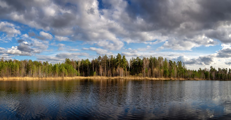 spring landscape of a lake with a forest on the shore, Russia, Ural, may