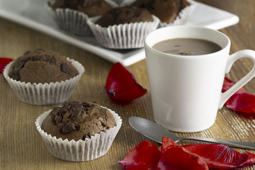 Cup of cocoa and chocolate muffins.