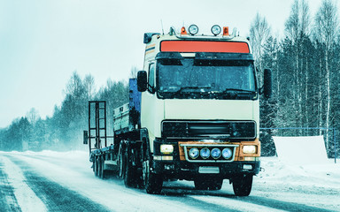 Truck in Snowy winter Road Finland in Lapland reflex