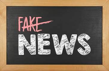 Black school chalkboard with FAKE NEWS words