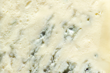 Background of blue cheese with Gorgonzola mold, traditional soft blue Italian cheese