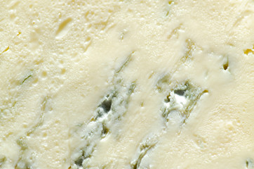 Background of blue cheese with Gorgonzola mold, traditional soft blue Italian cheese