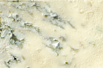 Background of blue cheese with Gorgonzola mold, traditional soft blue Italian cheese