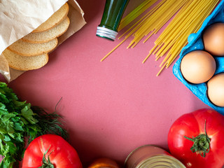 Food supplies on pink background, top view with copy space