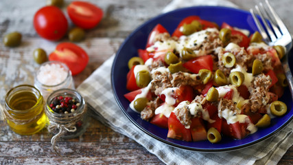 Selective focus. Fitness salad with tuna and olives and tartar sauce. Diet food.