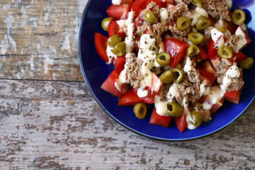 Selective focus. Fitness salad with tuna and olives and tartar sauce. Diet food.