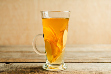 Healthy hot beverage with lemon, ginger and spices for protection in flu season. Selective focus. Shallow depth of field.
