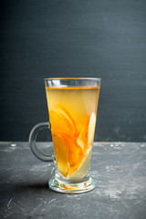 Healthy hot beverage with lemon, ginger and spices for protection in flu season. Selective focus. Shallow depth of field.