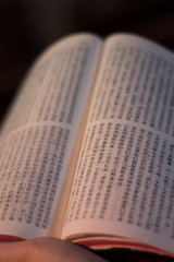 Libro de la biblia escrito en chino con una luz que colorea el libro.