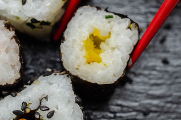 Close up of  yellow pepper hosomaki roll, traditional Japanese food