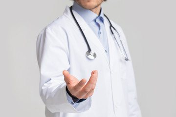 Unrecognizable Male Doctor Holding Virtual Object In His Hand, Cropped