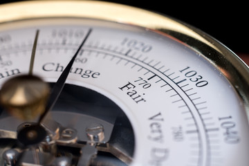 needle of a barometer pointing at the word change. close up with the word Fair in focus